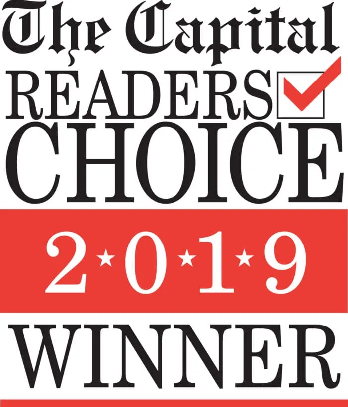 Logo with text "The Capital Readers Choice 2019 Winner" in black and red, featuring a red checkmark in a square box.