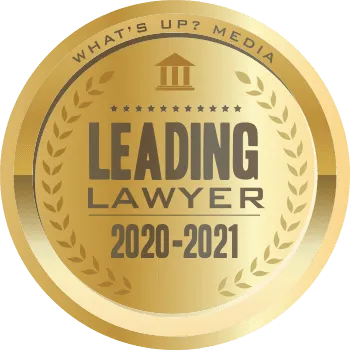 Gold circular badge with text "What's Up? Media Leading Lawyer 2020-2021" and laurel wreath design.