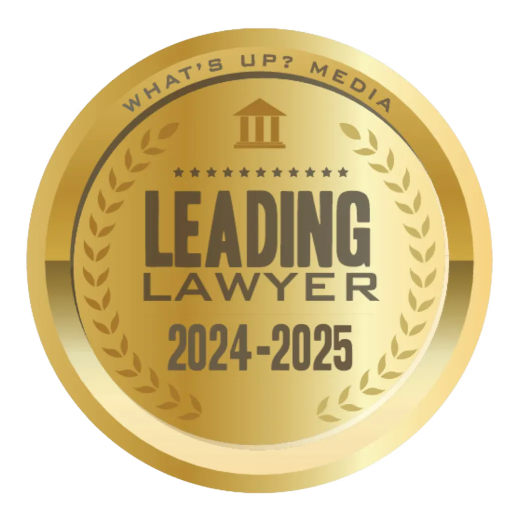 Gold circular emblem with laurel wreaths and text "Leading Lawyer 2024-2025" and "What's Up? Media.